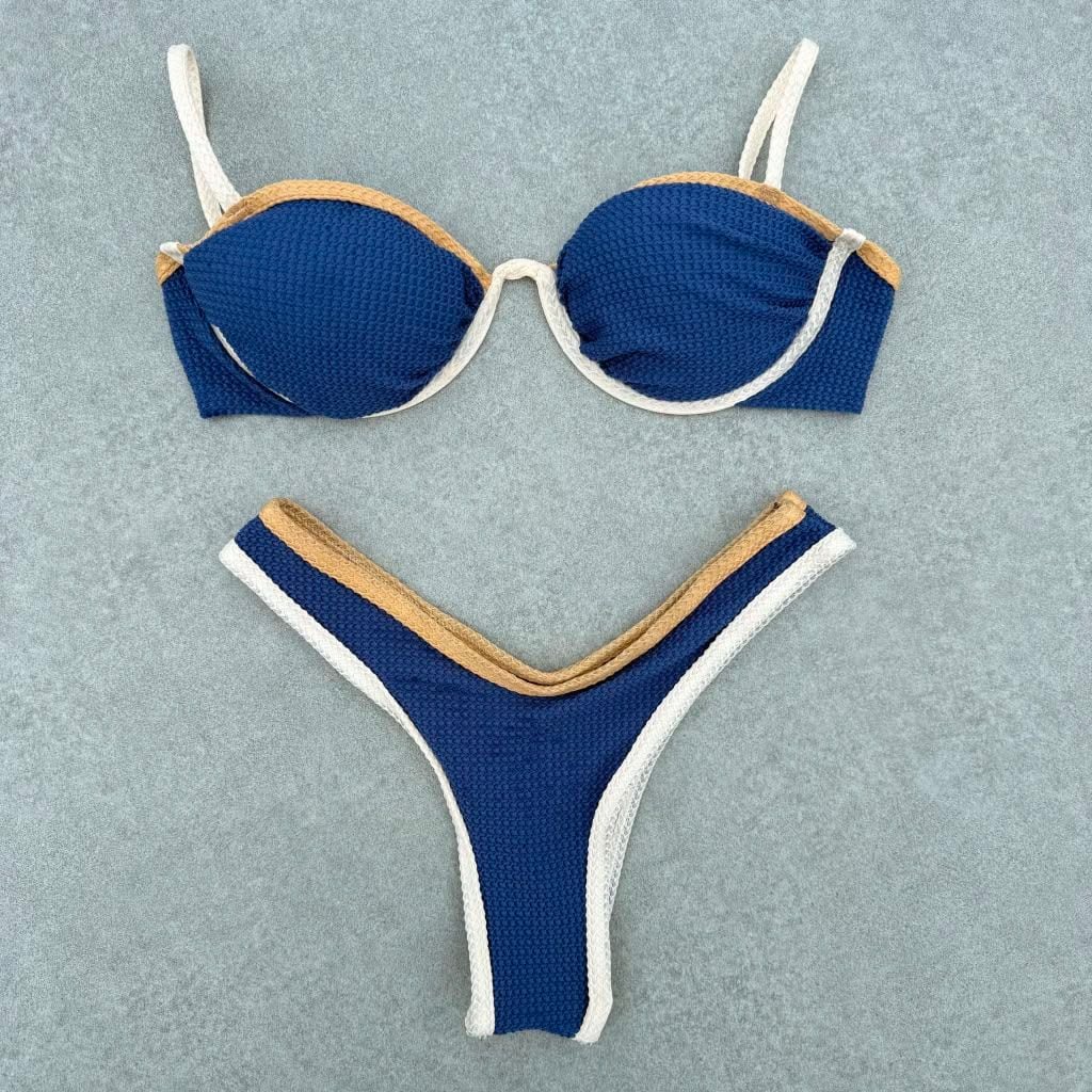 Azzurra bikini laid flat, in deep blue, sand and off-white