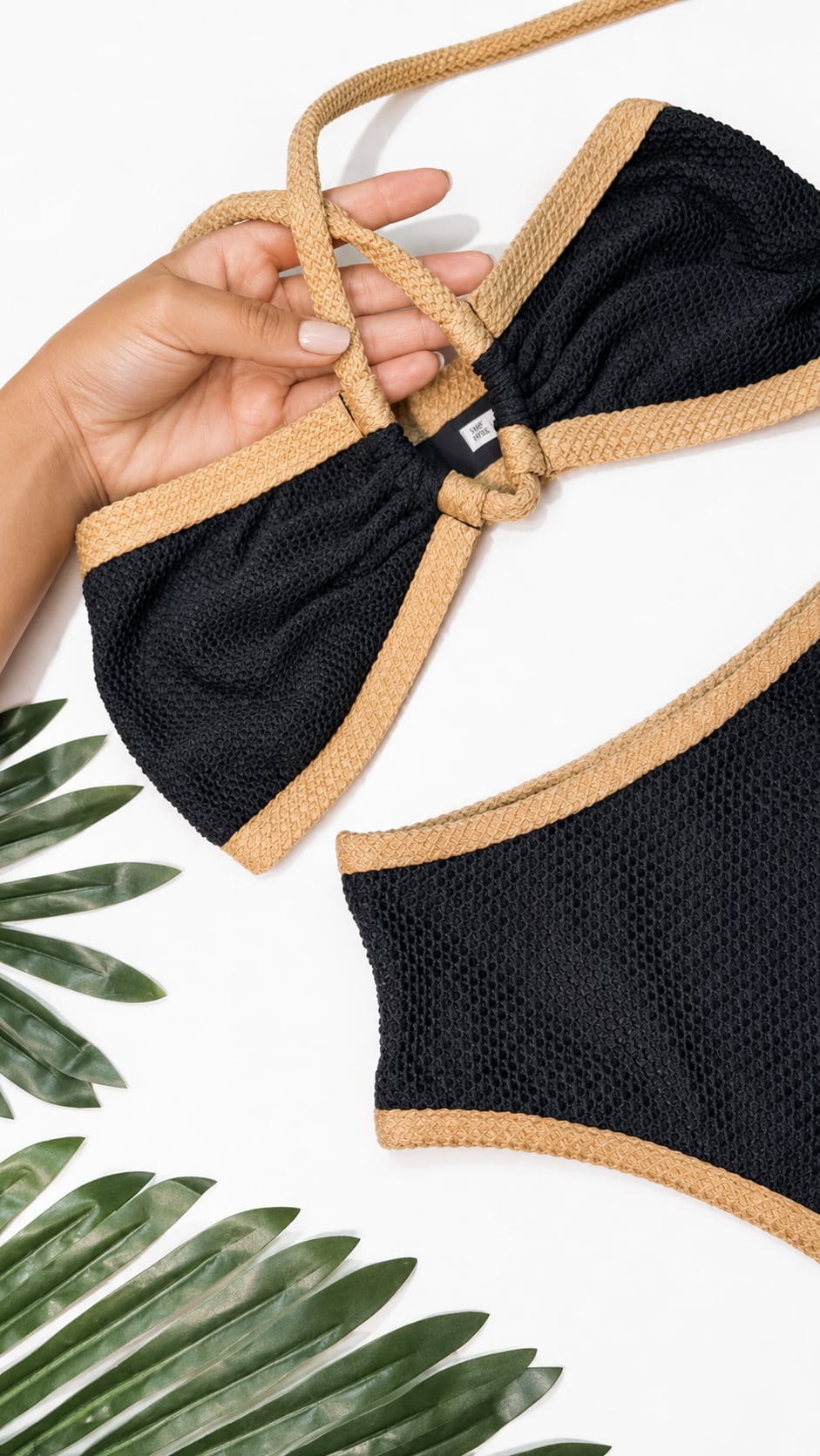 Notte bikini held up, in black and sand