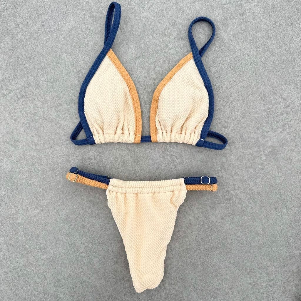 Sole bikini laid flat, in off-white, deep blue and sand